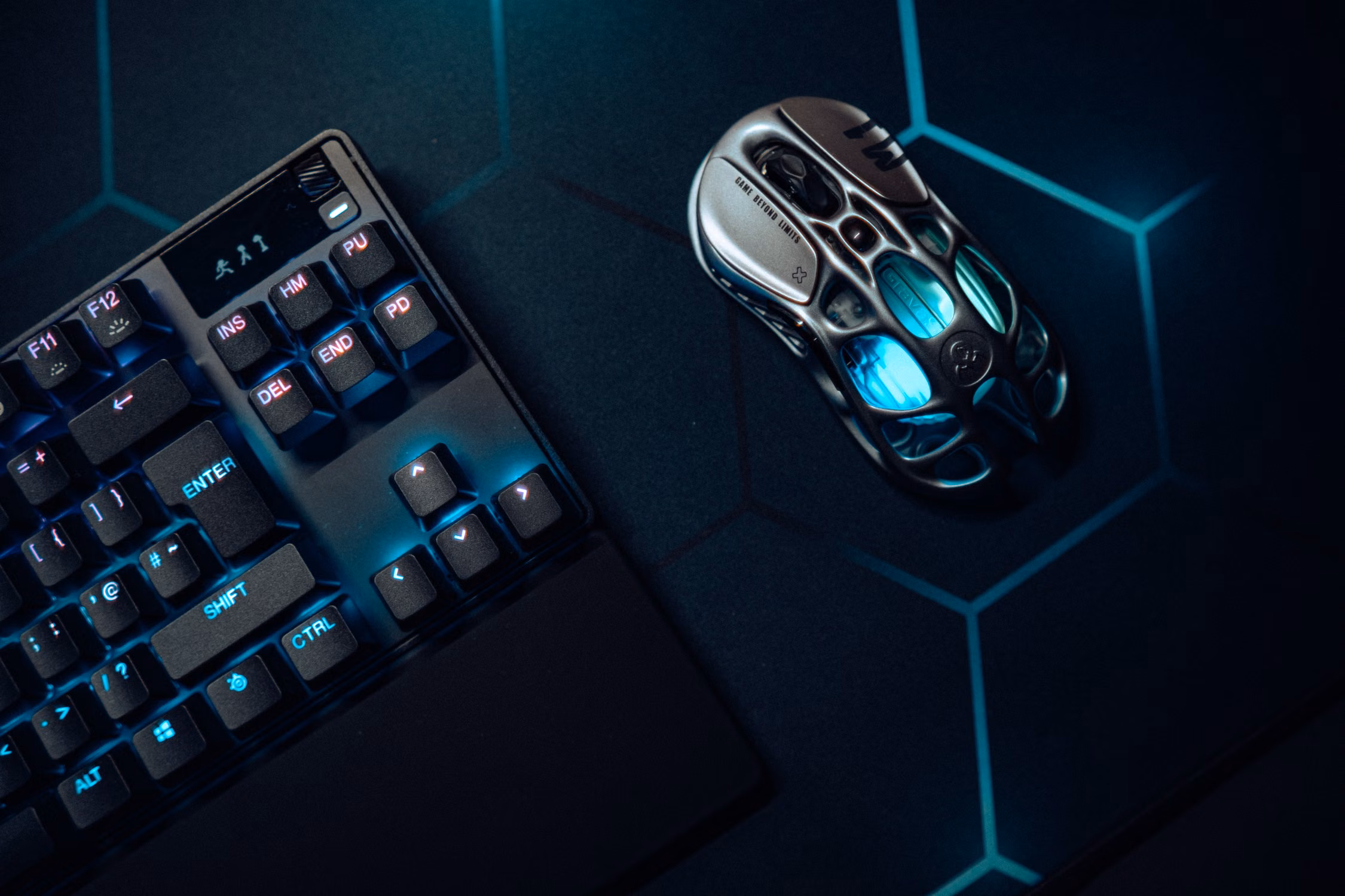 Close-up shot of a gaming keyboard and mechanical mouse under soft workspace light